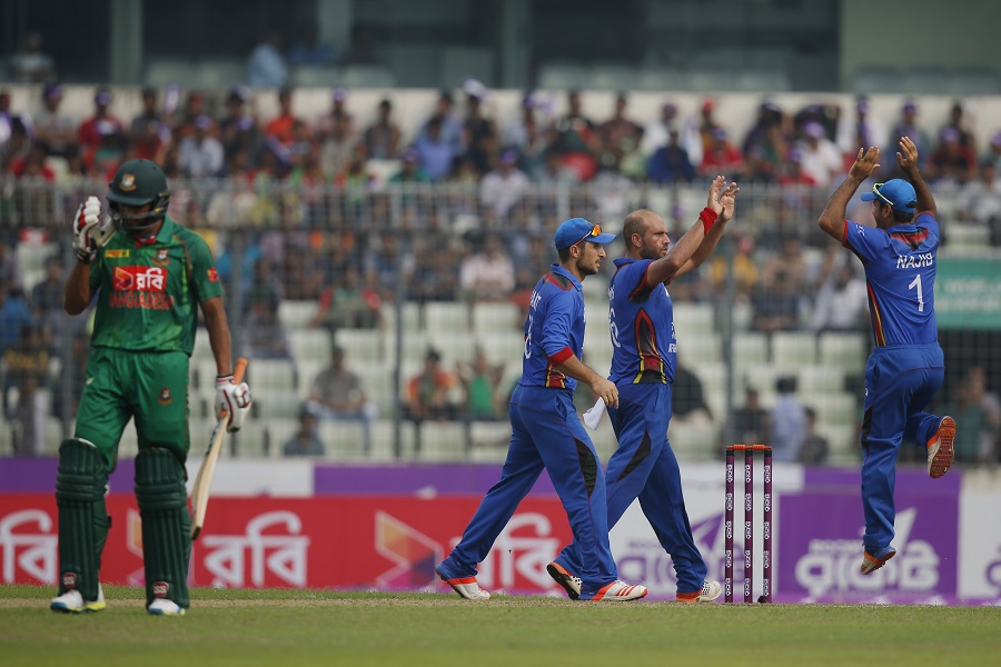 Afghanistan's Mirwais Ashraf, second right, celebrates with his teammates the dismissal of Bangladesh's Tamim Iqbal, unseen, during the second one-day international cricket match in Dhaka, Bangladesh, Wednesday, Sept. 28, 2016. (AP Photo/A.M. Ahad)