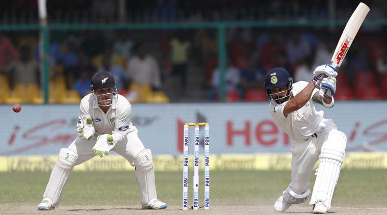 India's captain Virat Kohli, right, bats on the fourth day of their first cricket test match against New Zealand at Green Park Stadium in Kanpur, India, Sunday, Sept. 25, 2016. (AP Photo/ Tsering Topgyal)