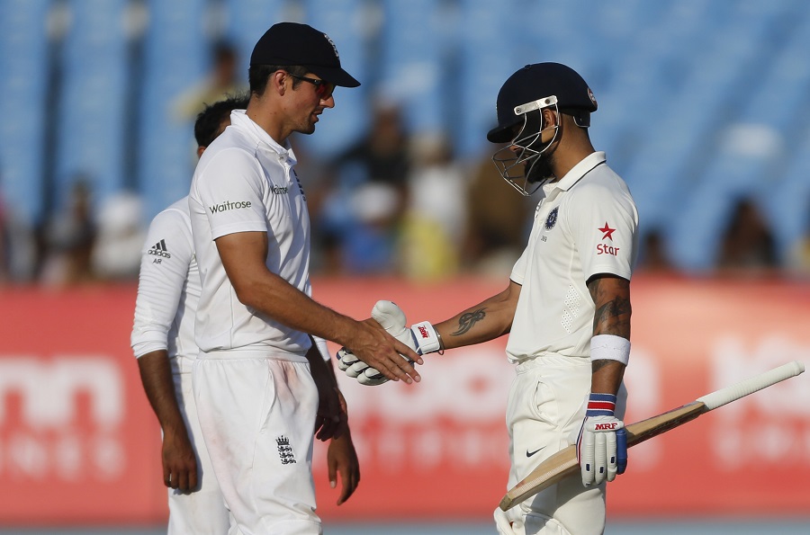 Indian cricket captain Virat Kohl, right, shakes hand with England's cricket captain Alastair Cook at the end of the fifth day of their first cricket test match between India and England in Rajkot, India, Sunday, Nov. 13, 2016. (AP Photo/Rafiq Maqbool)