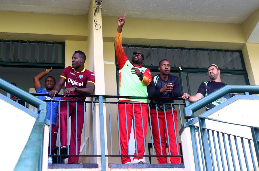 Zimbabwe players react on the balcony of the changing rooms during the third tri-nation One Day International (ODI) cricket match between Zimbabwe and West Indies at Queens Sports Club in Bulawayo on November 19, 2016.  / AFP / Jekesai Njikizana        (Photo credit should read JEKESAI NJIKIZANA/AFP/Getty Images)