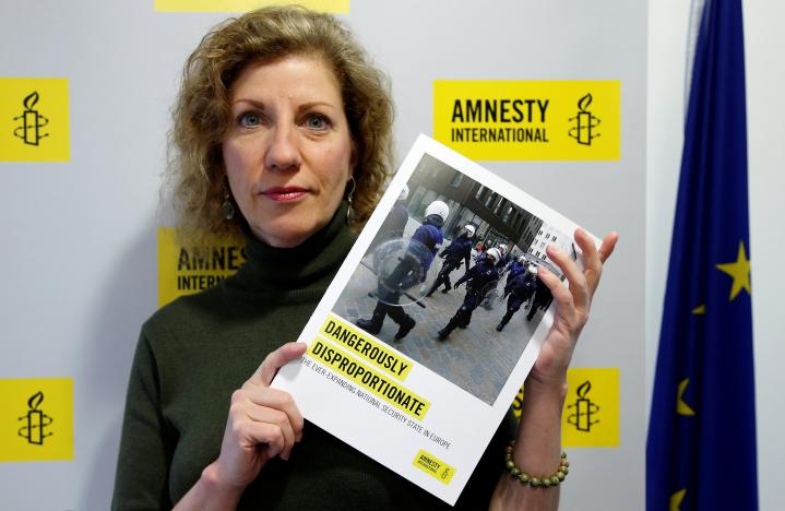 Julia Hall, Amnesty International's expert on counter terrorism, poses with a report on the effect of counter terrorism measures on human rights across Europe, in Brussels, Belgium, January 17, 2017. REUTERS/Francois Lenoir