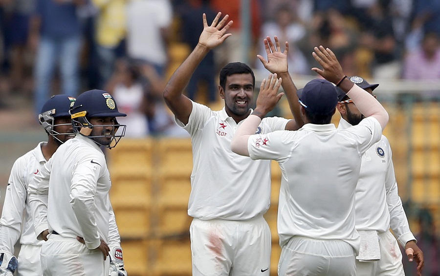 India's Ravichandran Ashwin, facing camera, celebrates the dismissal of Australia's Mitchell Marsh during the fourth day of their second test cricket match in Bangalore, India, Tuesday, March 7, 2017. (AP Photo/Aijaz Rahi)