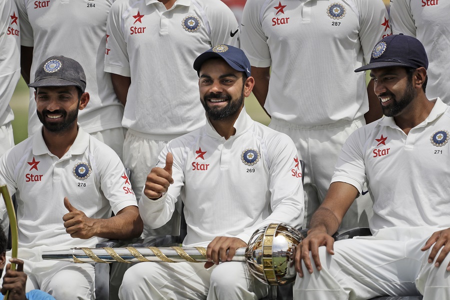 India's captain Virat Kohli, center gestures as the team poses with the Border-Gavaskar Trophy after winning the test cricket series against Australia in Dharmsala, India, Tuesday, March 28, 2017. India won the four-match series 2-1. (AP Photo/Tsering Topgyal)
