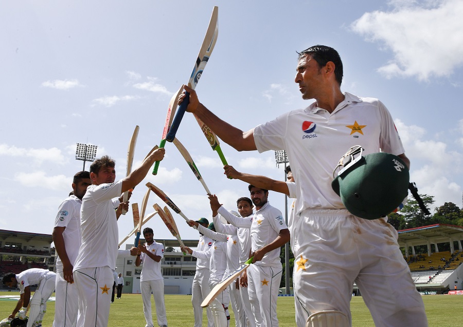 Members of the Pakistan team form a honor guard for batsman Younis Khan who was dismissed for 35 when batting for the last time before retirement on the fourth days play of the final test match against the West Indies at the Windsor Park Stadium in Roseau, Dominica on May 13, 2017.   Khan was caught by Kieran Powell off the bowling of Devendra Bishoo for 35 runs. / AFP PHOTO / MARK RALSTON        (Photo credit should read MARK RALSTON/AFP/Getty Images)