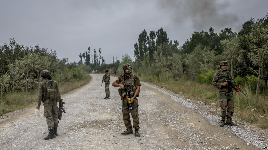 Indian army soldiers stands guard near the site of gun battle in Pulwama about 35 Kilometres south of Srinagar, Indian controlled Kashmir,  Saturday, Aug. 26, 2017. Anti-India rebels in Kashmir stormed a police camp in the disputed region Saturday, killing two paramilitary soldiers and a police officer, an official said.(AP Photo/Dar Yasin)