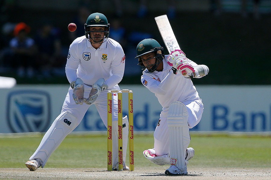 Bangladesh's batsman Mushfiqur Rahim (R) is watched by South Africa's wicketkeeper Quinton de Kock as he plays a shot during the third day of the second Test cricket match between South Africa and Bangladesh in Bloemfontein on October 8, 2017. / AFP PHOTO / MARCO LONGARI (Photo credit should read MARCO LONGARI/AFP/Getty Images)