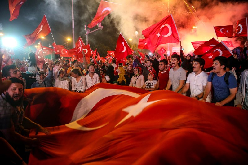 ISTANBUL, TURKEY - JULY 29: People wave a giant Turkish Flag during a protest against Parallel State/Gulenist Terrorist Organization's failed military coup attempt at Sarachane in Istanbul, Turkey on July 29, 2016. Parallel State is a terrorist organization leaded by U.S.-based cleric Fetullah Gulen, who is accused of a long-running campaign to overthrow the state through infiltrating into Turkish institutions, particularly the military, police and judiciary, forming a parallel state. (Photo by Berk Ozkan/Anadolu Agency/Getty Images)
