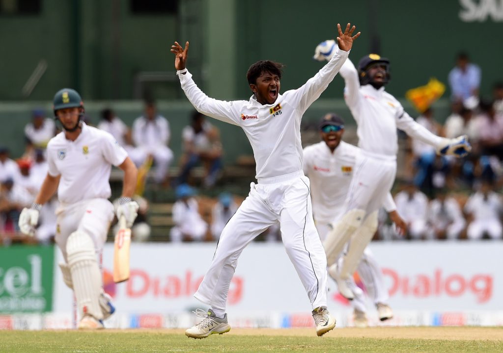 Sri Lankan cricketer Akila Dananjaya (2L) celebrates after he dismissed South Africa's Theunis de Bruyn (L) during the second day of their second Test match between Sri Lanka and South Africa at the Sinhalese Sports Club (SSC) international cricket stadium at the capital city of Colombo on July 21, 2018. / AFP PHOTO / ISHARA S.  KODIKARA