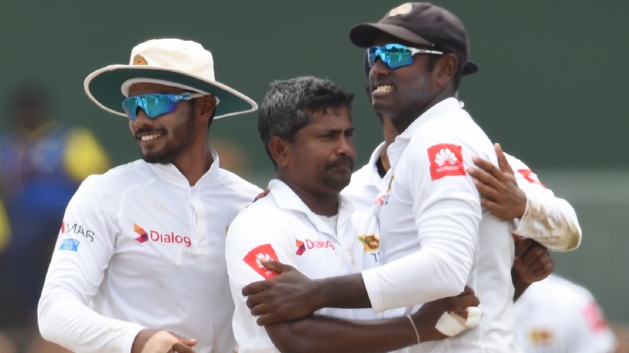Sri Lankan cricketer Rangana Herath (C) celebrates with teammates after he dismissed South Africa's Temba Bavuma during the fourth day of their second Test match between Sri Lanka and South Africa at the Sinhalese Sports Club (SSC) international cricket stadium in Colombo on July 23, 2018. / AFP PHOTO / ISHARA S. KODIKARA