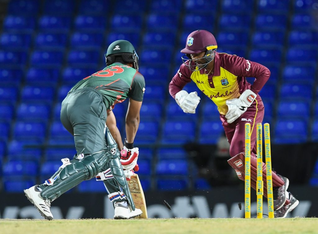 Tamim Iqbal (L) of Bangladesh dismiss by Denesh Ramdin (R) of West Indies during the 1st T20i match between West Indies and Bangladesh at Warner Park, Basseterre, St. Kitts, on July 31, 2018 / AFP PHOTO / Randy Brooks