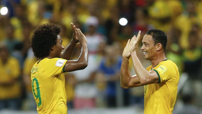 Brazil's Ricardo Oliveira, right, celebrates with teammate Willian after scoring against Venezuela during a 2018 World Cup qualifying soccer match in Fortaleza, Brazil, Tuesday, Oct. 13, 2015. (AP Photo/Andre Penner)