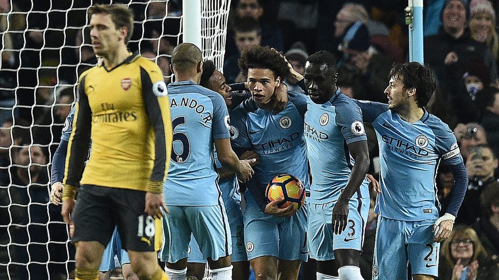 Manchester City's German midfielder Leroy Sane (C) celebrates scoring his team's first goal during the English Premier League football match between Manchester City and Arsenal at the Etihad Stadium in Manchester, north west England, on December 18, 2016. / AFP / Oli SCARFF / RESTRICTED TO EDITORIAL USE. No use with unauthorized audio, video, data, fixture lists, club/league logos or 'live' services. Online in-match use limited to 75 images, no video emulation. No use in betting, games or single club/league/player publications.  /         (Photo credit should read OLI SCARFF/AFP/Getty Images)