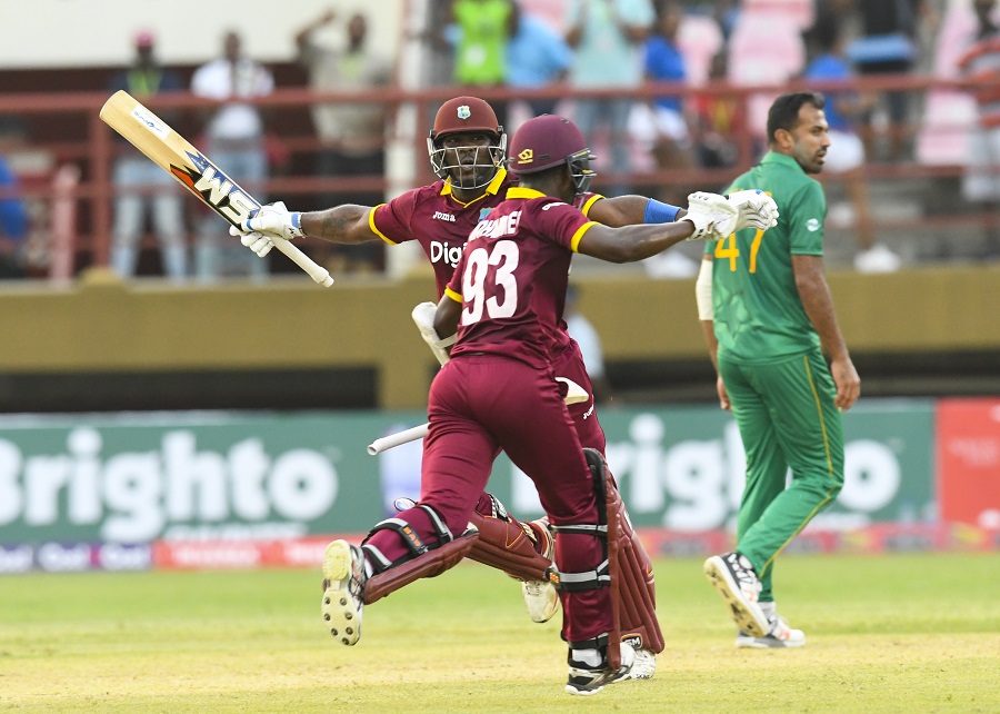 Wahab Riaz (R) of Pakistan walks off the field as Ashley Nurse (L) and Jason Mohammed (C) of West Indies celebrate winning the 1st ODI match between West Indies and Pakistan at Guyana National Stadium, Providence, Guyana, on April 7, 2017.  / AFP PHOTO / Randy BROOKS