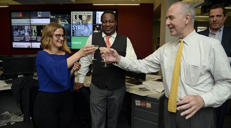 From left, The New York Daily News reporter Sarah Ryley celebrates with News Editor Robert Moore, and Editor In Chief Arthur Browne on Monday, April 10, 2017, in New York, after The New York Daily News and ProPublica won the 2017 Pulitzer Prize in public service. The award was given for uncovering how authorities used an obscure law, originally enacted to crack down on prostitution in Times Square in the 1970s, to evict hundreds of people, mostly poor minorities, from their homes. (Jefferson Siegel/The Daily News via AP)