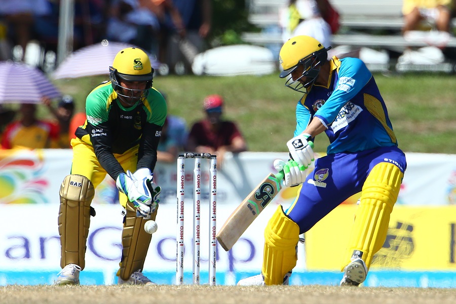 FORT LAUDERDALE, FL - AUGUST 05: In this handout image provided by CPL T20,Shoaib Malki of Barbados Tridents plays a cut shot as Kumar Sangakarra of the Jamaica Tallawahs looks on during Match 3 of the 2017 Hero Caribbean Premier League between Barbados Tridents v Jamaica Tallawahs at Central Broward Regional Park Stadium on August 5, 2017 in Fort Lauderdale, Florida. (Photo by Ashley Allen - CPL T20 via Getty Images)