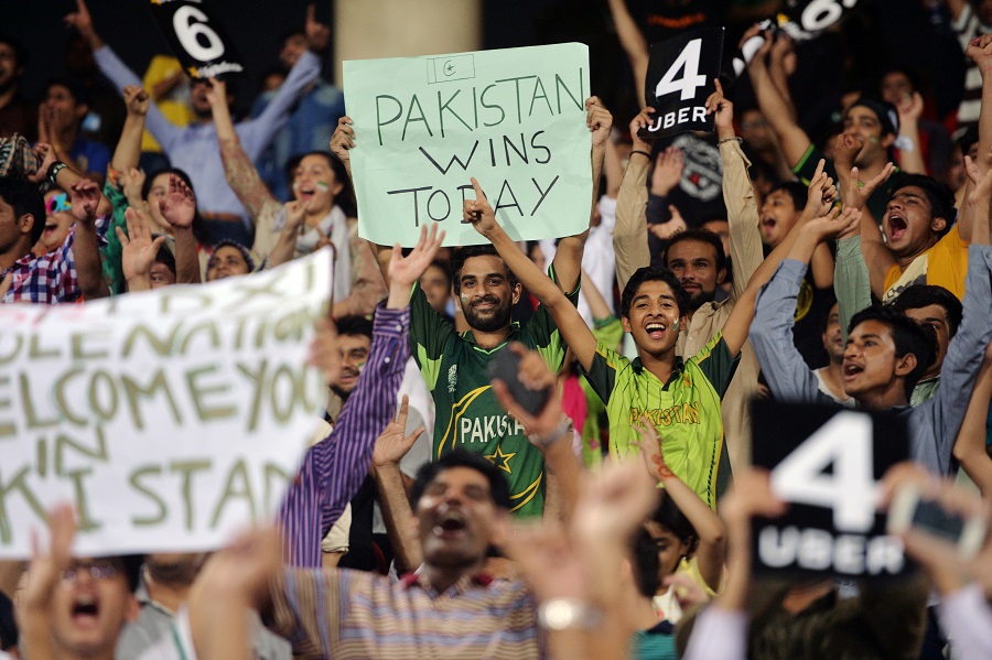 Pakistani spectators cheer as they watch the first Twenty20 international match between the World XI and Pakistan at the Gaddafi Cricket Stadium in Lahore on September 12, 2017. / AFP PHOTO / AAMIR QURESHI        (Photo credit should read AAMIR QURESHI/AFP/Getty Images)