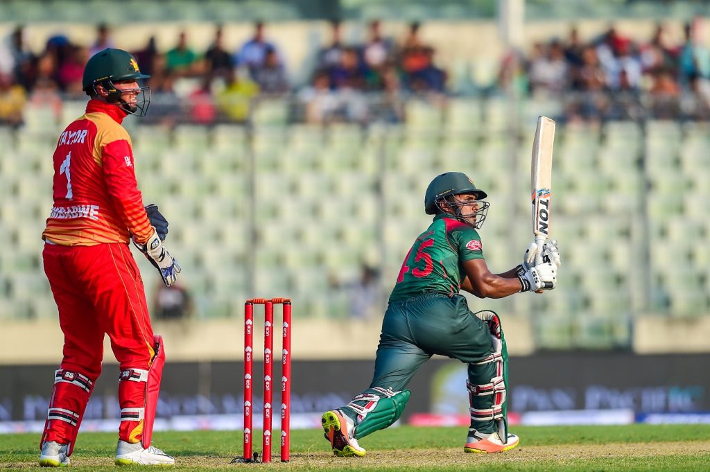 Bangladesh cricketer Imrul Kayes (R) plays a shot as Zimbabwe's wicketkeeper Brendan Taylor (L) looks on during the first one day international (ODI) cricket match between Bangladesh and Zimbabwe at the Sher-e-Bangla National Cricket Stadium in Dhaka on October 21, 2018. (Photo by MUNIR UZ ZAMAN / AFP)        (Photo credit should read MUNIR UZ ZAMAN/AFP/Getty Images)