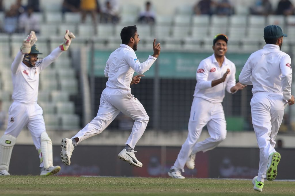 Bangladesh's Mehedi Hasan (C) celebrates with his teammates after the dismissal of West Indies' Kieran Powell during the second day of the second Test cricket match between Bangladesh and West Indies in Dhaka on December 1, 2018. (Photo by Salahuddin Ahmed / AFP)