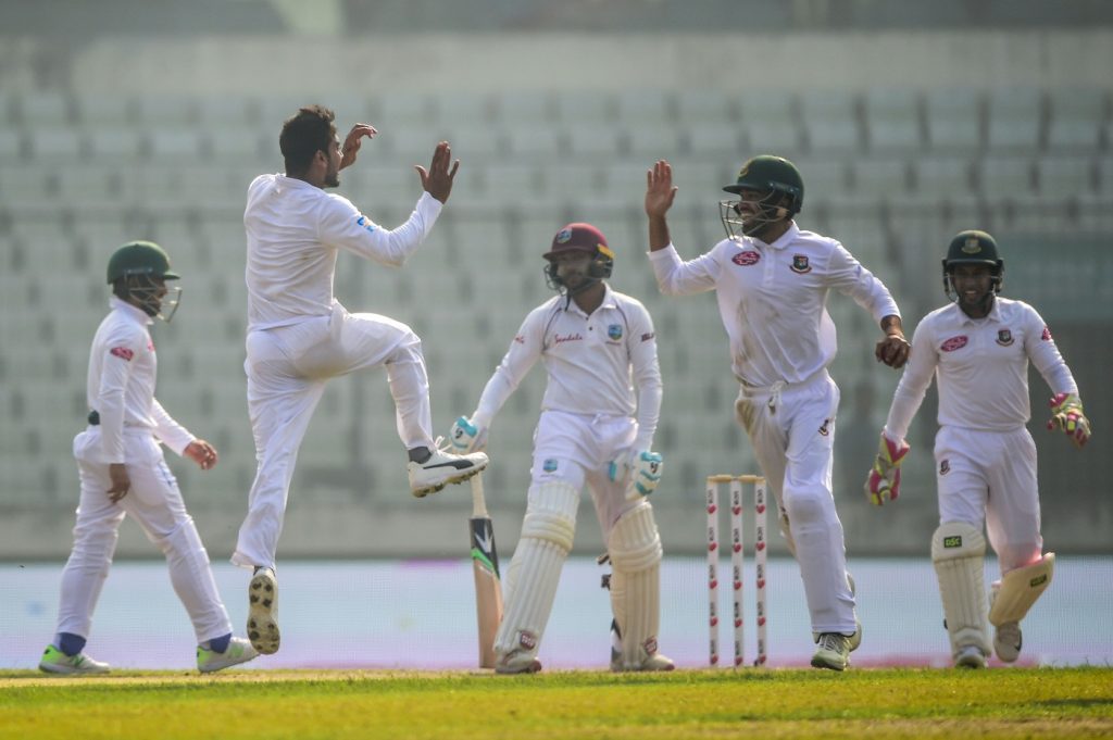 Bangladesh cricketer Mehidy Hasan (2nd L) celebrates with his teammates after the dismissal of the West Indies cricketer Devendra Bishoo (C) during the third day of the second Test cricket match between Bangladesh and West Indies at the Sher-e-Bangla National Cricket Stadium in Dhaka on December 2, 2018. (Photo by MUNIR UZ ZAMAN / AFP)        (Photo credit should read MUNIR UZ ZAMAN/AFP/Getty Images)
